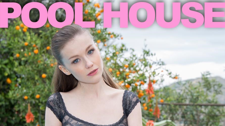 Brunette Emily Bloom poses solo outdoors near a pool house in 4K 60FPS VR video production with natural lighting.