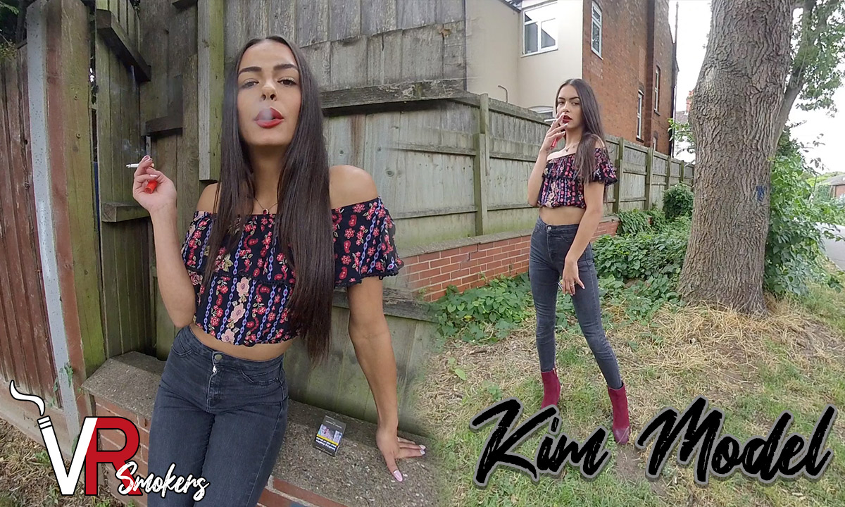 Kim Model poses in dark jeans during a solo outdoor VR Smokers non POV video featuring fetish themes and 60 FPS quality.