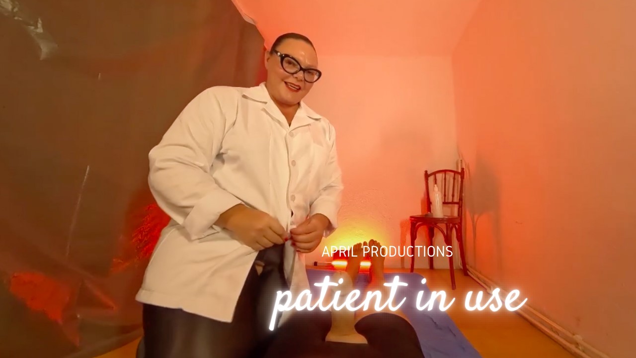 Brunette Mistress April performs sexual acts on a patient in a medical office setting for April Movie Productions in 4K VR POV.